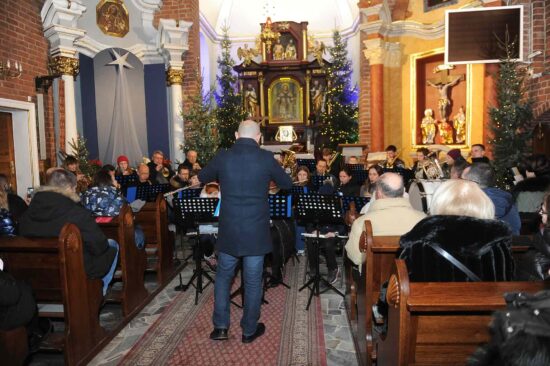 muzycy orkiestry dętej grają w kościele