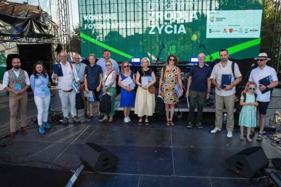 Na scenie stoją laureaci konkursu fotograficznego #PusczaŁączy „Źródło życia” 